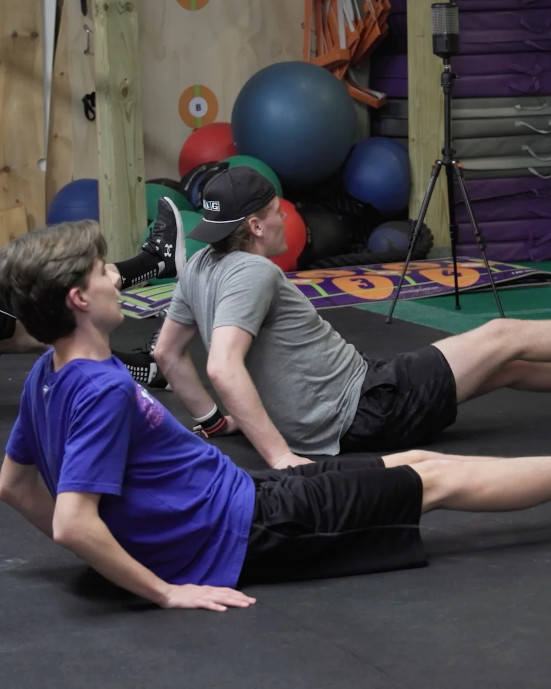 Two members working through a floor exercise side by side